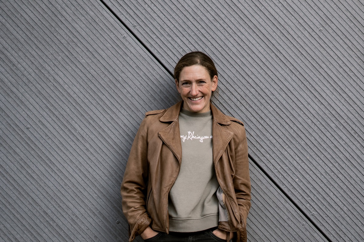 lederjacke, braun, sweatshirt, graue wand, frau